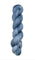A skein of hand-dyed fingering/sock yarn color grey