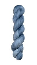 A skein of hand-dyed fingering/sock yarn color grey