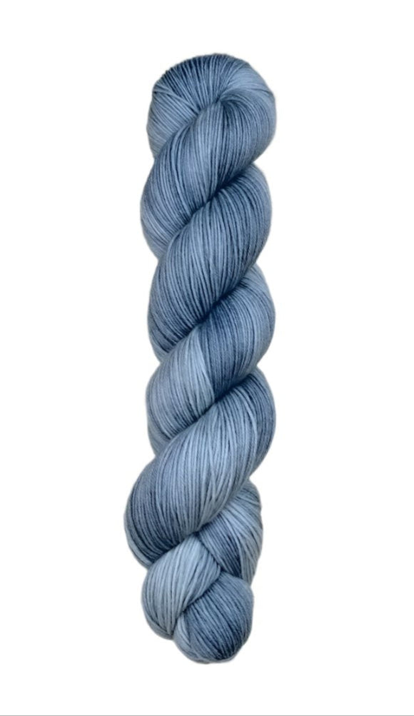 A skein of hand-dyed fingering/sock yarn color grey