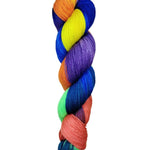 A skein of hand-dyed fingering/sock yarn color blue yellow orange purple salmon