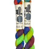 Two mini skeins of wool yarn hand dyed in Wyoming in the color green yellow blue orange purple