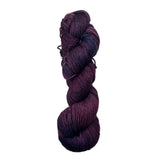 Purple and navy skein of yarn on a white background