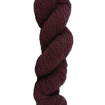 Wine colored skein of mountain meadow wool yarn on a white background