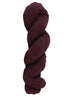 Wine colored skein of mountain meadow wool yarn on a white background