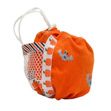 An orange fabric drawstring pouch with a white mesh pocket on the side, decorated with a pumpkin pattern and gray bat motifs, on a plain white background.