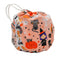 A small fabric drawstring bag with a Halloween print, featuring a peach-pink background with cartoon pumpkins, cats, witches, spiders, and stars, plus a white patterned side panel and white drawstring ties.