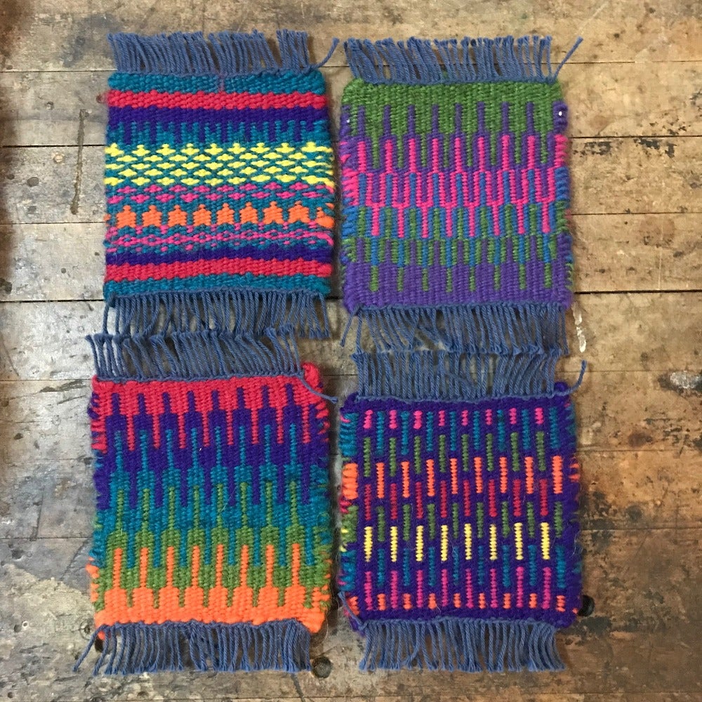 Four colorful woven coasters