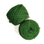 Two balls of dark green yarn on a plain white background, one wound into a cone and one into a flat spiral.