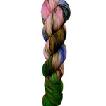 A skein of hand-dyed fingering/sock yarn color pink blue green brown