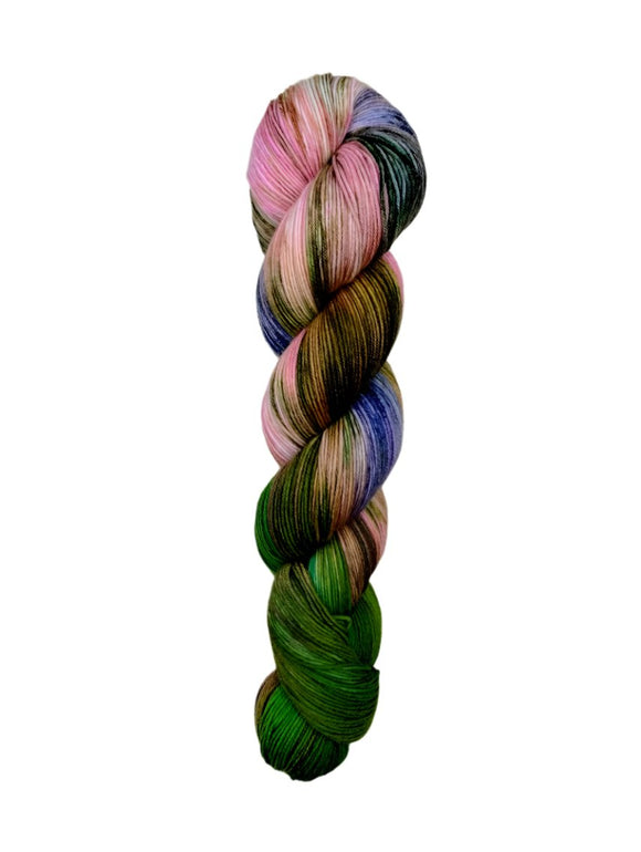 A skein of hand-dyed fingering/sock yarn color pink blue green brown
