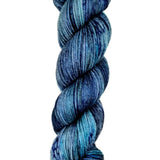A skein of hand-dyed fingering/sock yarn color blue grey black speckles