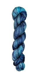 A skein of hand-dyed fingering/sock yarn color blue grey black speckles