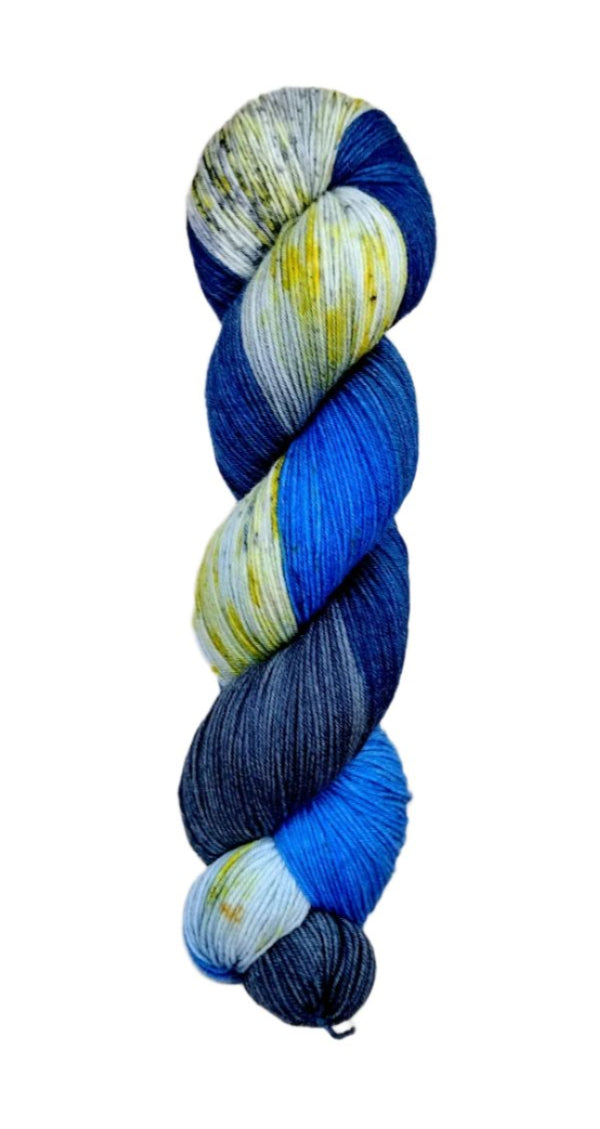 A skein of hand-dyed fingering/sock yarn color grey white blue navy black speckles