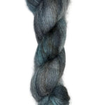 Skein of mohair silk yarn hand-dyed in Wyoming in the color grey blue black