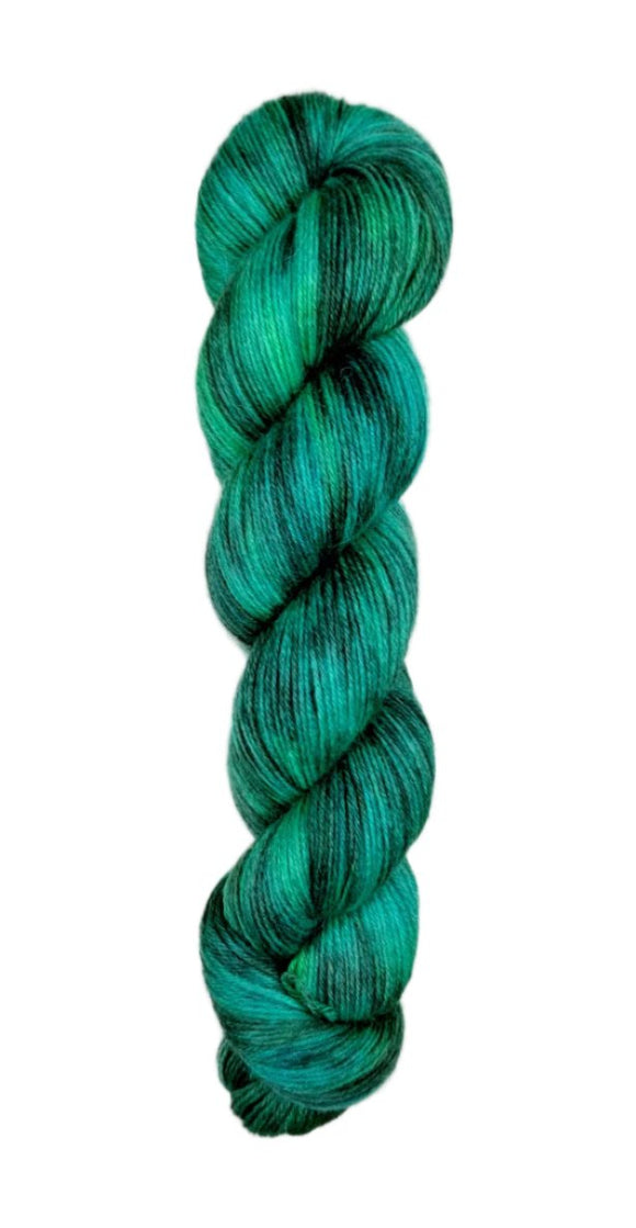 A skein of hand-dyed fingering/sock yarn color green black 
