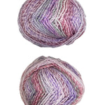 Two skeins of multicolored yarn on a white surface