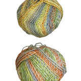 Two balls of multicolored yarn on a white surface