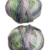 A variegated skein of yarn in the colors green mauve white grey
