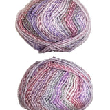 A variegated skein of yarn in the colors pink white grey mauve purple