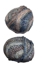 A variegated skein of yarn in the colors mauve white blue black grey navy
