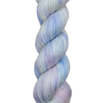 A skein of hand-dyed fingering/sock yarn color white pastel pink purple blue 
