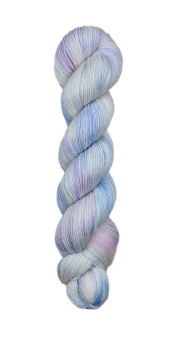 A skein of hand-dyed fingering/sock yarn color white pastel pink purple blue 