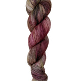 A skein of hand-dyed fingering/sock yarn color brown tan red speckles