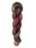 A skein of hand-dyed fingering/sock yarn color brown tan red speckles