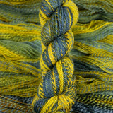 Skein of multicolored handspun looking wool yarn in the colors blue brown grey yellow 