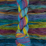 Skein of multicolored handspun looking wool yarn in the colors blue purple yellow orange green 