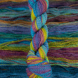 Skein of multicolored handspun looking wool yarn in the colors blue purple yellow orange green 