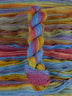 Skein of multicolored handspun looking wool yarn in the colors blue magenta orange yellow purple