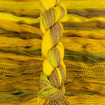 Skein of multicolored handspun looking wool yarn in the colors yellow brown green orange