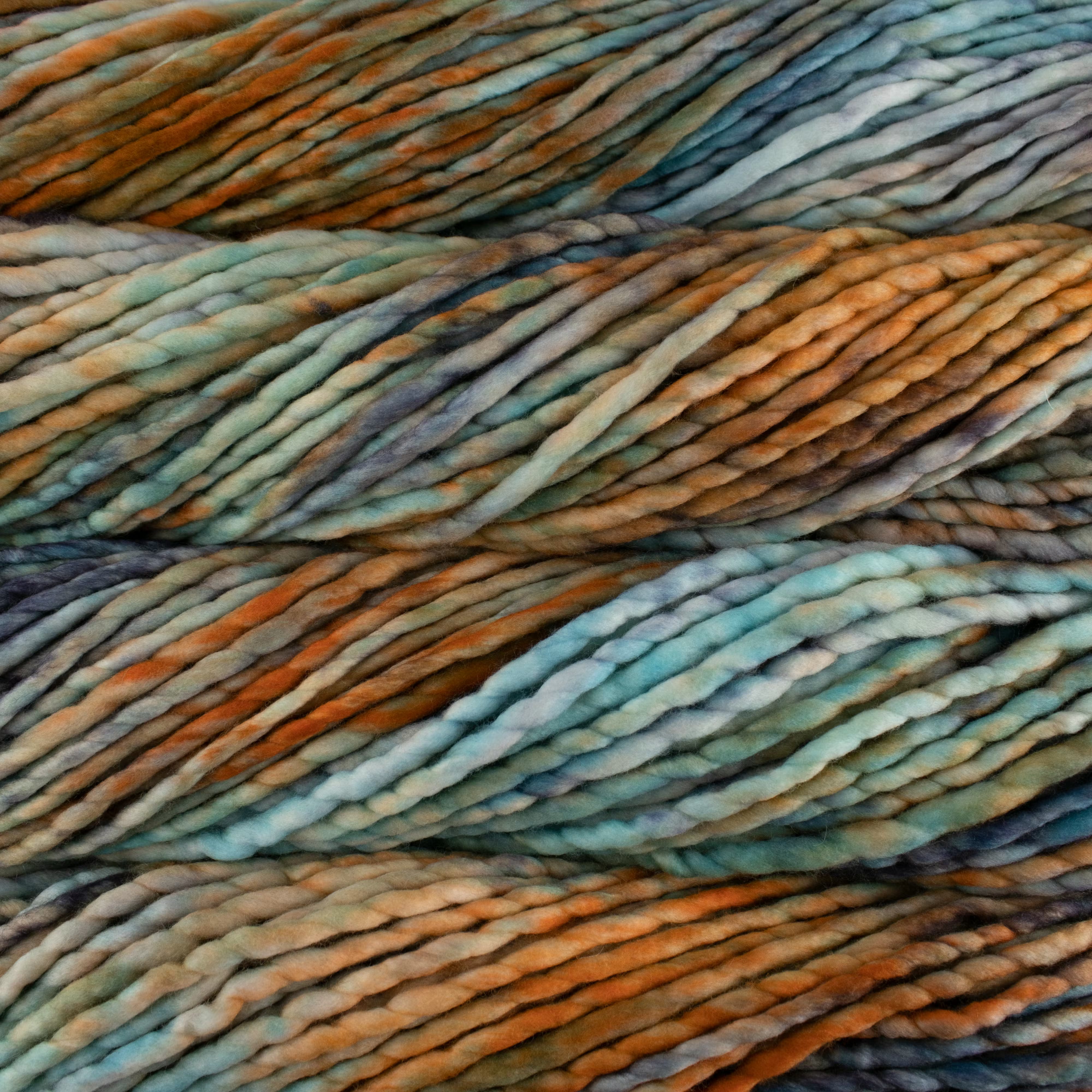Close-up of multicolored yarn with shades of blue, orange, and brown.