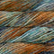 Close-up of multicolored yarn with shades of blue, orange, and brown.