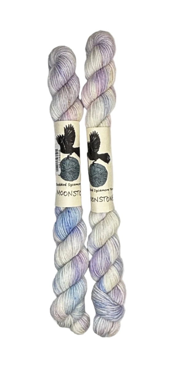 Two mini skeins of wool yarn hand dyed in Wyoming in the color white blue purple pink