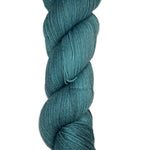 Skein of hand dyed fingering weight yarn in the color blue