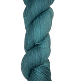 Skein of hand dyed fingering weight yarn in the color blue