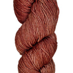 A skein of wool yarn in the color orangey rose