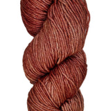 A skein of wool yarn in the color orangey rose