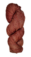 A skein of wool yarn in the color orangey rose