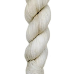 A skein of hand-dyed fingering/sock yarn color off-white grey