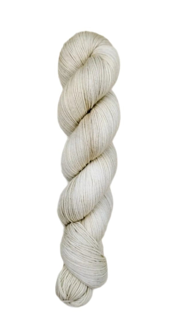 A skein of hand-dyed fingering/sock yarn color off-white grey