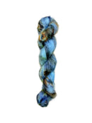 Skein of superkid mohair silk lace weight yarn color blue orange black