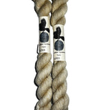 Two mini skeins of  off white yarn on a white background 