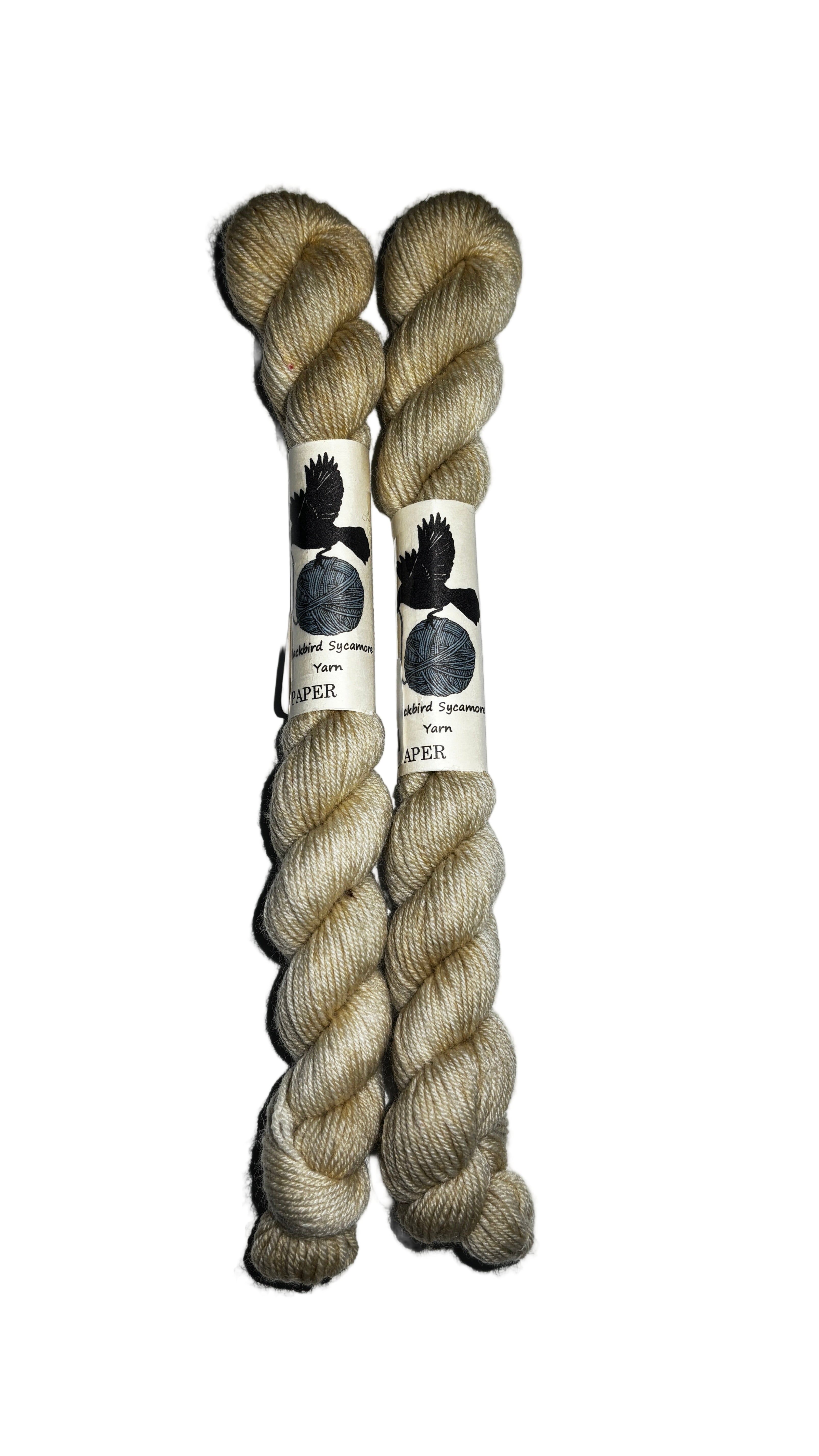 Two mini skeins of  off white yarn on a white background 