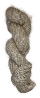 A skein of handspun angora yarn in a cream natural color