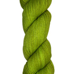 Skein of hand dyed fingering weight yarn in the color pea green 