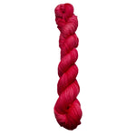 Braided pink yarn on a white background