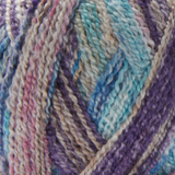 Close-up image of multi-colored yarn alongside a knit up swatch in the colors tan blue purple pink